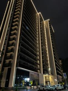 a large building with cars parked in front of it at Next Apartments Batumi with Sea View in Batumi