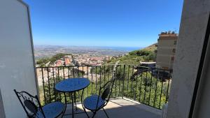 a balcony with chairs and a table with a view at Jenka in Caltabellotta
