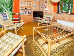 a living room with chairs and a table and a tv at 6 person holiday home in Spøttrup-By Traum in Lihme