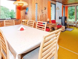a dining room with a white table and chairs at 6 person holiday home in Spøttrup-By Traum in Lihme