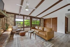 a living room with a couch and a chair at Hideout Cabin - private retreat just 15 mins from Wimberley! in Wimberley +25 photos