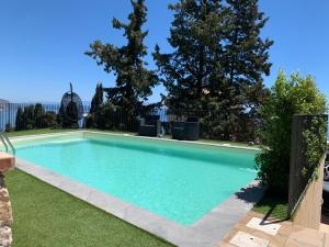 a swimming pool in a yard with trees at Villa Mimma in Taormina