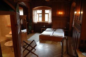 a bedroom with two beds and a sink and a window at Schloss Herberge Hohenerxleben in Hohenerxleben
