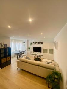 un soggiorno con un grande divano e un tavolo di Apartamento de lujo River Suites a Santander Altre 17 foto