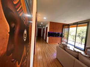 a living room with a military picture on the wall at Pousada Boutique Raio de Luz in Ouro Preto