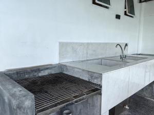 a kitchen counter with a sink and a sink at Langkawi Simfoni Platinum Suite in Kuah +96 photos