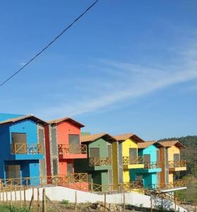 a row of colorful houses on top of a hill at VILLAGE Vista do Cruzeiro ITAITU in Jacobina