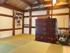 a room with a chest of drawers on the floor at 蔵の宿 隠れ蔵 Kakurekura Traditional Private Stay in Nagahama