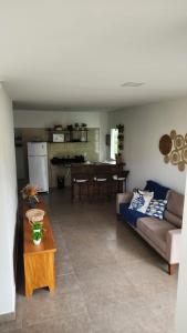 a living room with a couch and a table at VILLAGE Vista do Cruzeiro ITAITU in Jacobina +18 photos