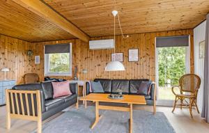 a living room with a couch and a table at Awesome Home In Haderslev With Wifi in Haderslev