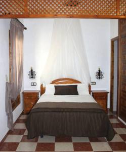 1 dormitorio con 1 cama, 2 vestidores y ventana en El Mirador, en Benamahoma