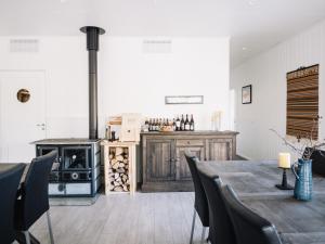 a kitchen with a wooden table and a stove at Trasti & Trine Boutique Hotel in Alta