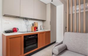 a kitchen with a sink and a stove top oven at Gorgeous Apartment In Omisalj in Omišalj