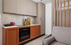 a kitchen with a sink and a stove at Awesome Apartment In Omisalj in Omišalj