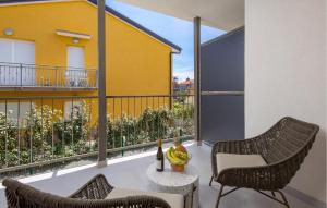 a balcony with two chairs and a table at Awesome Apartment In Omisalj in Omišalj +34 photos