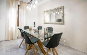 a dining room with a glass table and chairs at Casa La Dea in Bettolle