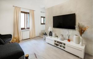 a living room with a flat screen tv on a wall at Casa La Dea in Bettolle
