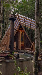 a small house with a pool in the woods at Parque Repuleufu Chiloé in Ancud