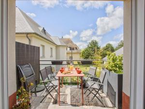 a patio with a table and chairs on a balcony at Appartement familial à 250m du golf et de la plage, parking inclus - Varaville - FR-1-788-16 in Varaville