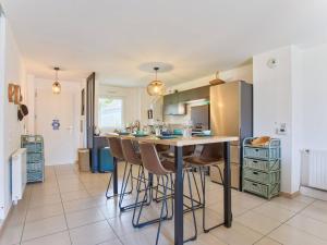 a kitchen with a island with bar stools at Appartement familial à 250m du golf et de la plage, parking inclus - Varaville - FR-1-788-16 in Varaville