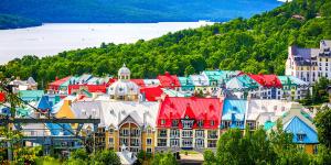 a group of buildings with red and blue roofs at Tremblant Naturo-Spa, LAC, PISCINE, TENNIS, GYM in Lac-Superieur