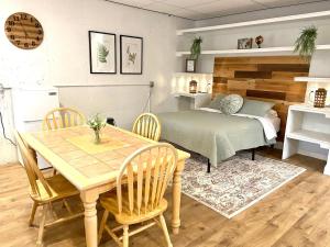 a dining room with a table and a bed at Suite Dreams in Cedar City