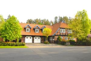 a large house with an orange roof and white doors at Ferienwohnung Stedden in Stedden