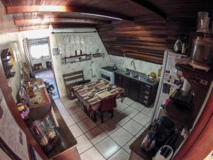 an overhead view of a kitchen with a table and a stove at Cabanna Hostel & Turismo in Candelária