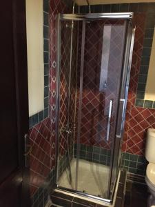 a shower with a glass door in a bathroom at Varosi 4 Seasons in Edessa +95 photos