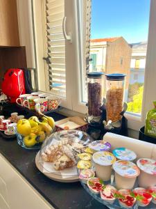 a counter topped with plates of food on a counter top at Mongibello Rooftop in Mondello +30 photos