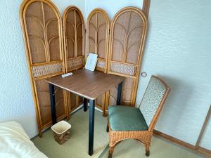 a room with a wooden table and a chair at Azumi Relax Lodge in Azumino +23 photos