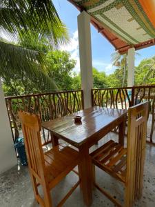 a wooden table and chairs on the porch of a house at Drift in Arugam Bay