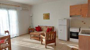 a kitchen with a couch and a table in a room at Giannos Apartments in Agia Effimia