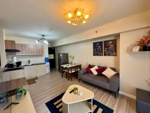 a living room and kitchen with a couch and a table at Avida Riala Condotel T4-1103 in Cebu City