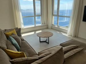 a living room with a couch and a table at Villa Infinia, Lefkada in Sivota