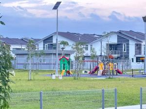 a park with a playground in front of a building at Lylinz bandar layangkasa in Kampong Kong Kong