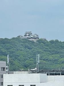 a building sitting on top of a hill at Terminal Hotel Matsuyama in Matsuyama