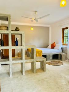 a living room with a bed and a shelf at Kandy Living Homestay in Kandy