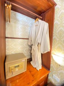 a bathroom with a sink and a shirt hanging on a counter at Luang Prabang Sirikili Villa River View in Luang Prabang