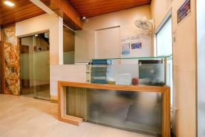 a kitchen with a large glass display case at Hotel U Life Residency Mumbai in Mumbai