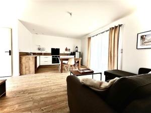 a living room with a couch and a table in it at Al País Del Mesturet in Graulhet