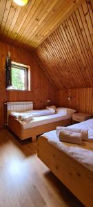 a room with three beds in a wooden cabin at Holiday Home Stevas in Žabljak