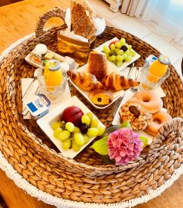 a basket of bread and pastries on a table at Lodge Sainte Sara in Aigues-Mortes +5 photos