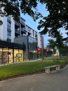 a park with a bench in front of a building at GREEN PARK Apartments and rooms for guests in Asenovgrad