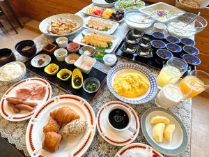a table with many plates of food on it at Awone Shirakami Juniko in Fukaura