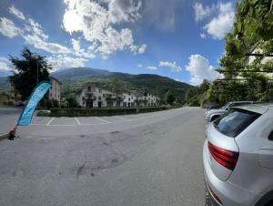 a car parked on the side of a road at Hotel Eternità in Malonno