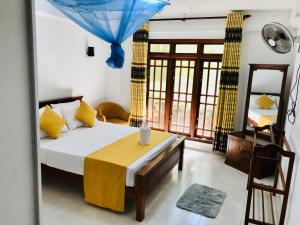 a bedroom with a bed and a table in a room at Ella Jayamali Holiday Pavilion in Ella +284 photos