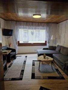 a living room with a couch and a table at Ferienhaus Heimes in Klotten