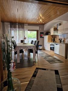 a kitchen and dining room with a table and chairs at Ferienhaus Heimes in Klotten
