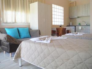 a large bedroom with two beds and a couch at Bright Sea - Studios in Limenas
